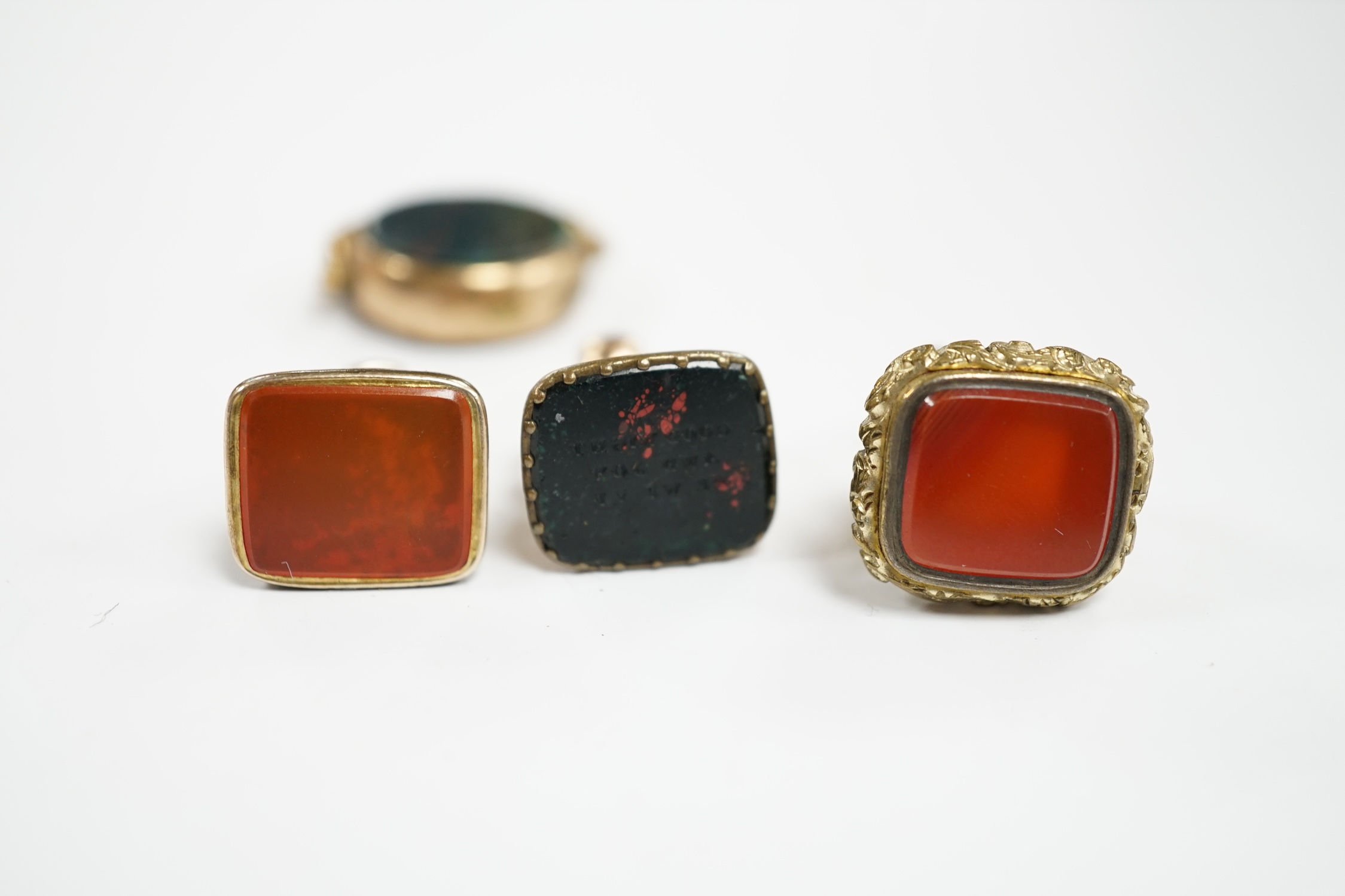 Four assorted 19th century fob seals including a 9ct and chalcedony set spinning fob, 32mm.